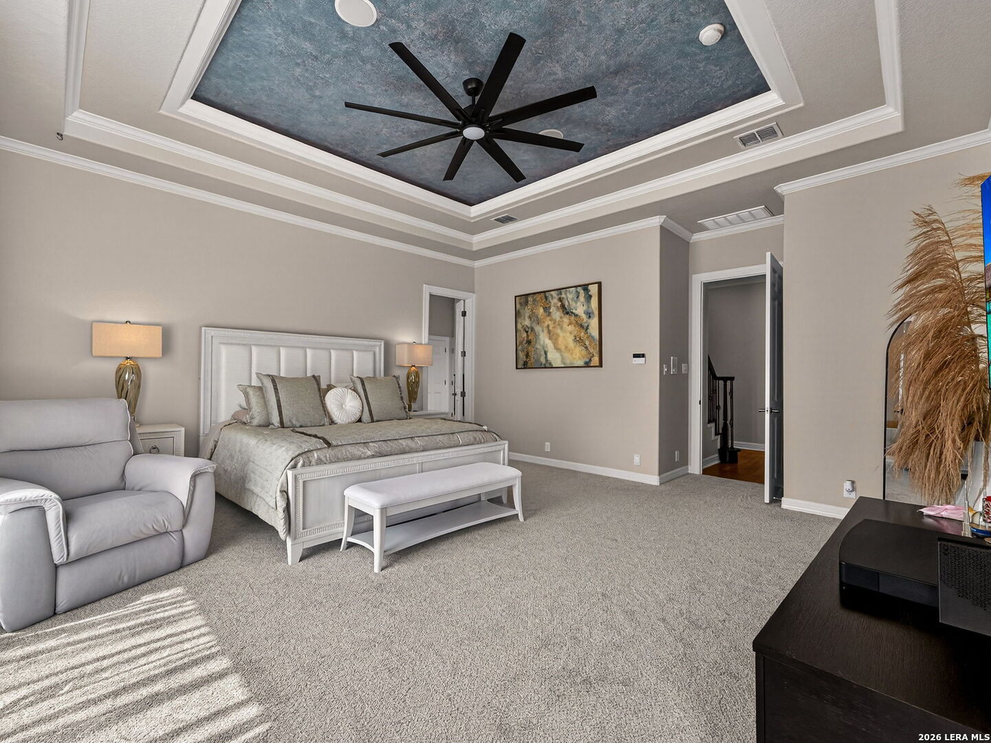 24511 Bogey Ridge San Antonio, TX 78258 - Photo 18 of 39 a bedroom with furniture and a ceiling fan