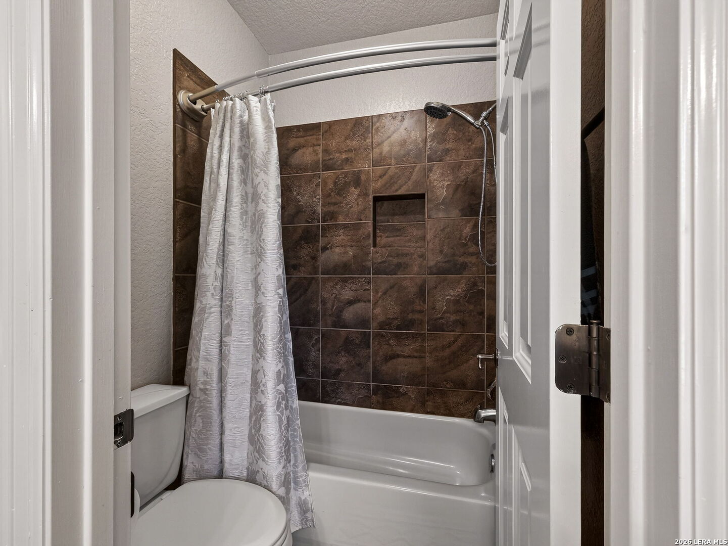 24511 Bogey Ridge San Antonio, TX 78258 - Photo 23 of 39 a bathroom with a shower and a toilet