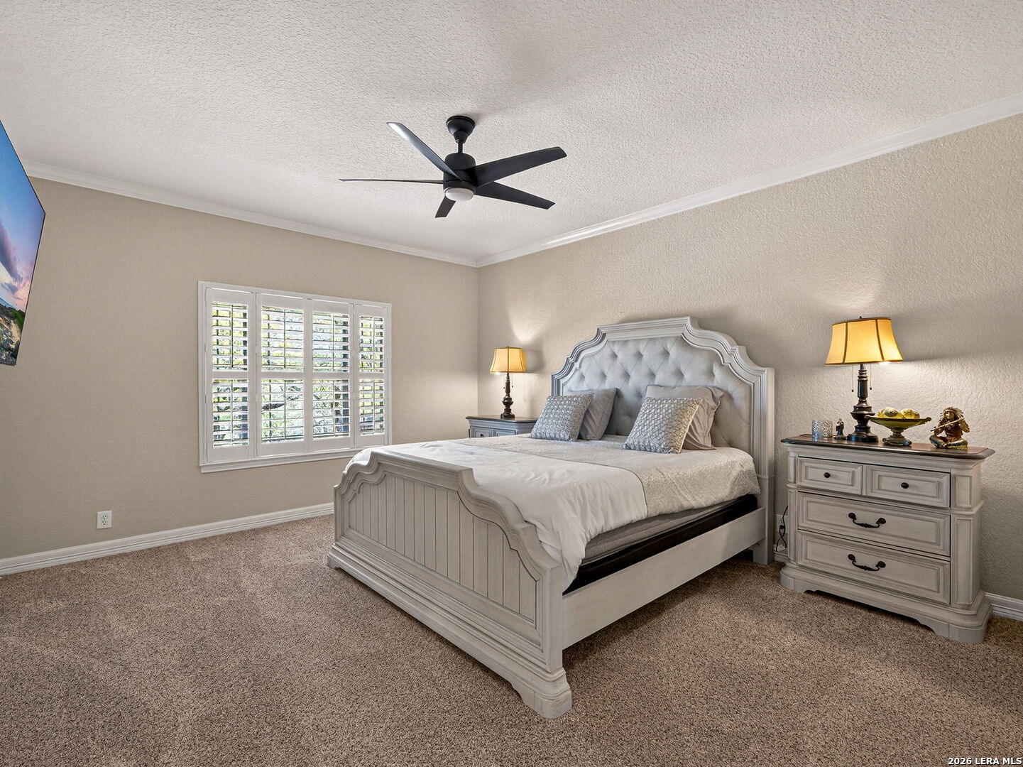 24511 Bogey Ridge San Antonio, TX 78258 - Photo 24 of 39 a bedroom with a bed and a window