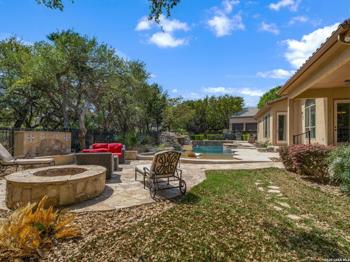 24511 Bogey Ridge San Antonio, TX 78258 - Photo 35 of 39 a view of a patio with table and chairs potted plants with wooden fence
