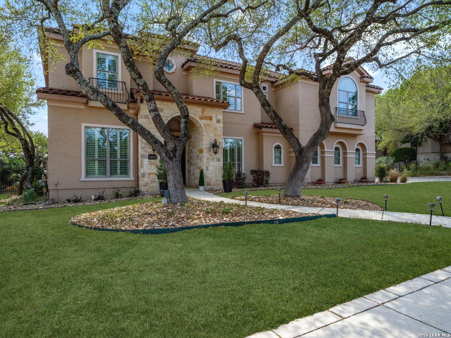 24511 Bogey Ridge San Antonio, TX 78258 - Photo 4 of 39 a front view of a house with a garden