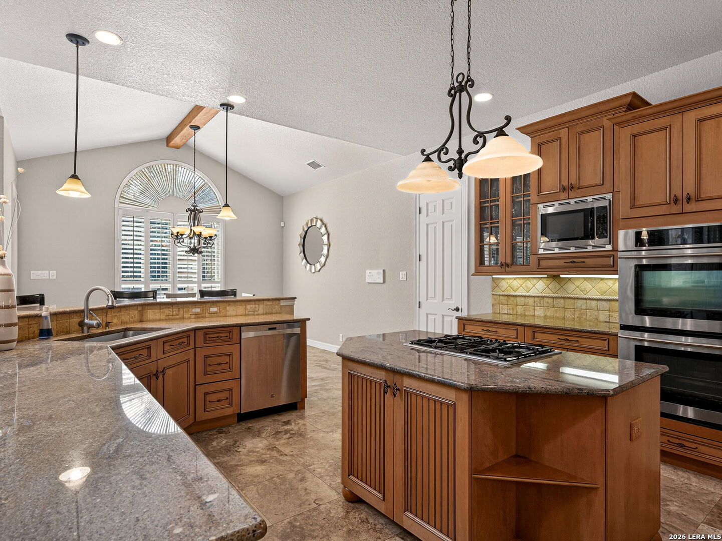 24511 Bogey Ridge San Antonio, TX 78258 - Photo 9 of 39 a kitchen with stainless steel appliances granite countertop a stove a sink and a refrigerator