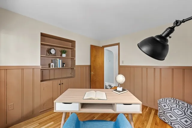 a bathroom with a toilet sink vanity and mirror