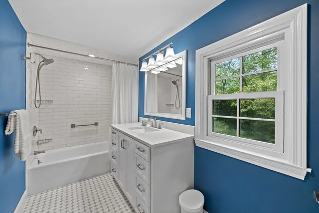 a white toilet sitting next to a window