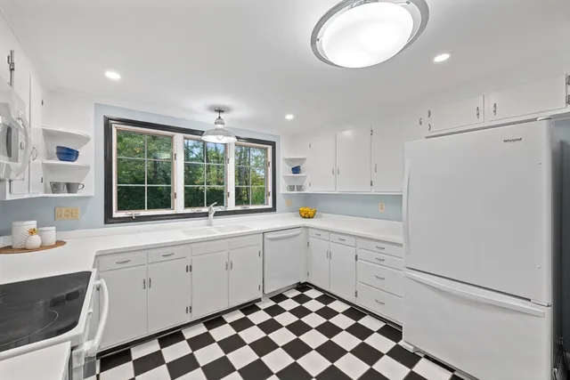 a kitchen with a stove a sink and a refrigerator