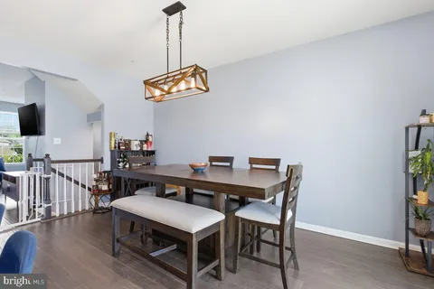 a view of a dining room with furniture wooden floor and a chandelier