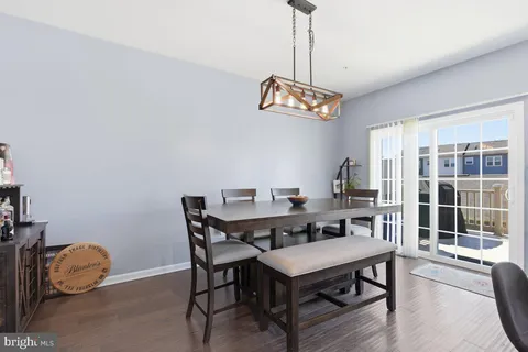 a view of a dining room with furniture wooden floor and chandelier