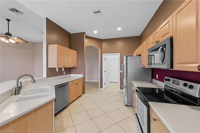 a kitchen with stainless steel appliances a sink stove and cabinets
