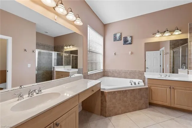 a bathroom with a tub sink and mirror