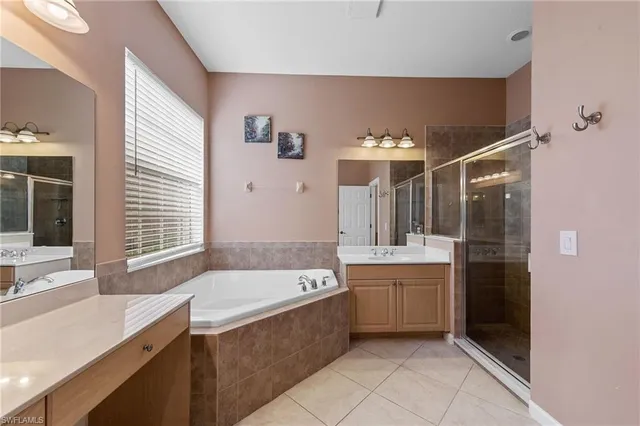 a bathroom with a tub sink and mirror