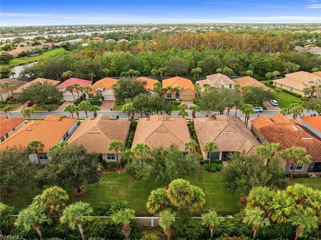an aerial view of a houses with a yard