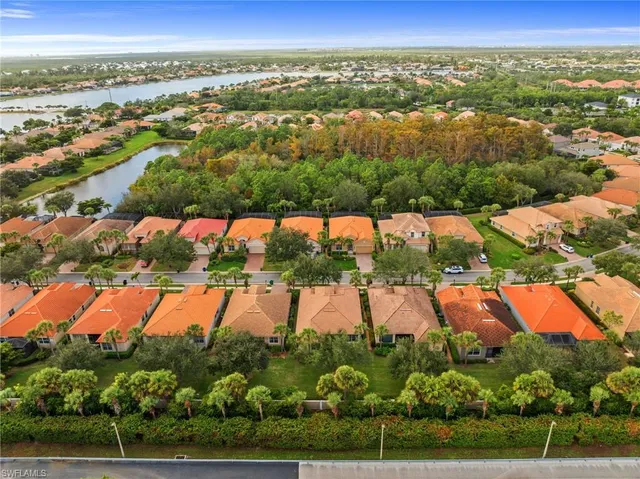 an aerial view of residential houses with outdoor space and swimming pool