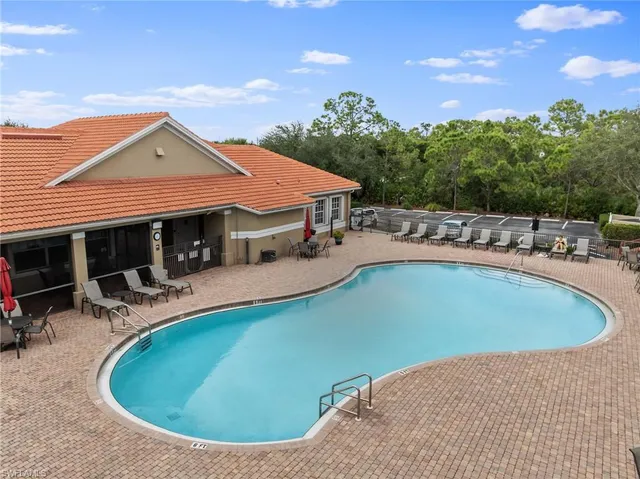 a view of a house with swimming pool and sitting area