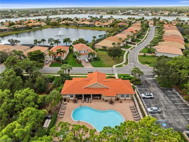 an aerial view of residential houses with outdoor space and river