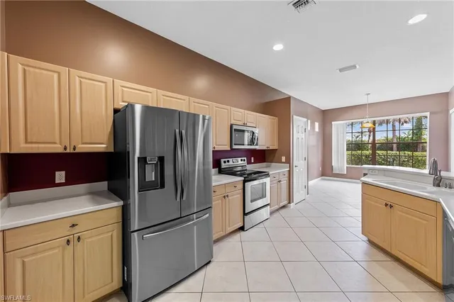 a kitchen with granite countertop cabinets and stainless steel appliances