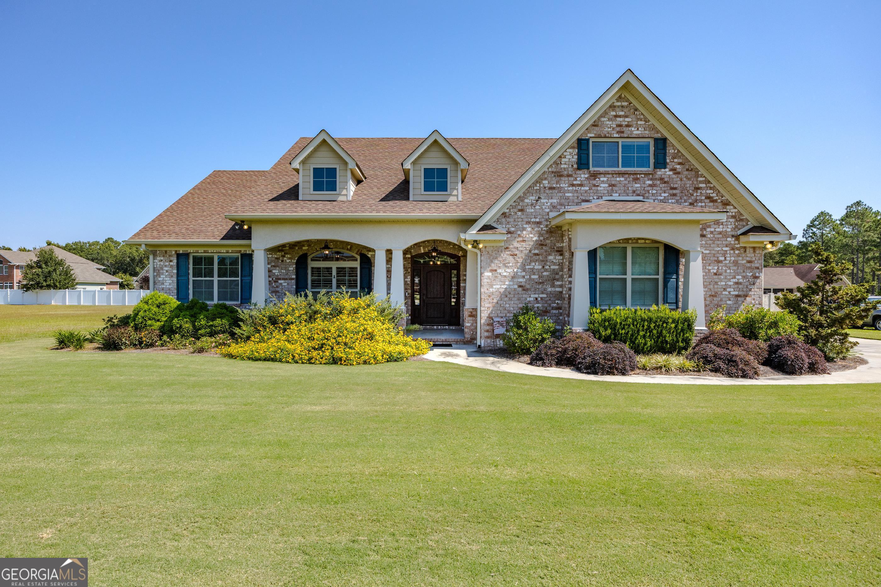 a front view of a house with a garden