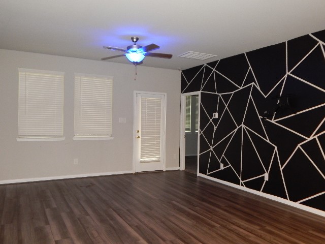 7103 Silverleaf Oak Street Conroe, TX 77304 - Photo 3 of 20 a room with wooden floor and windows