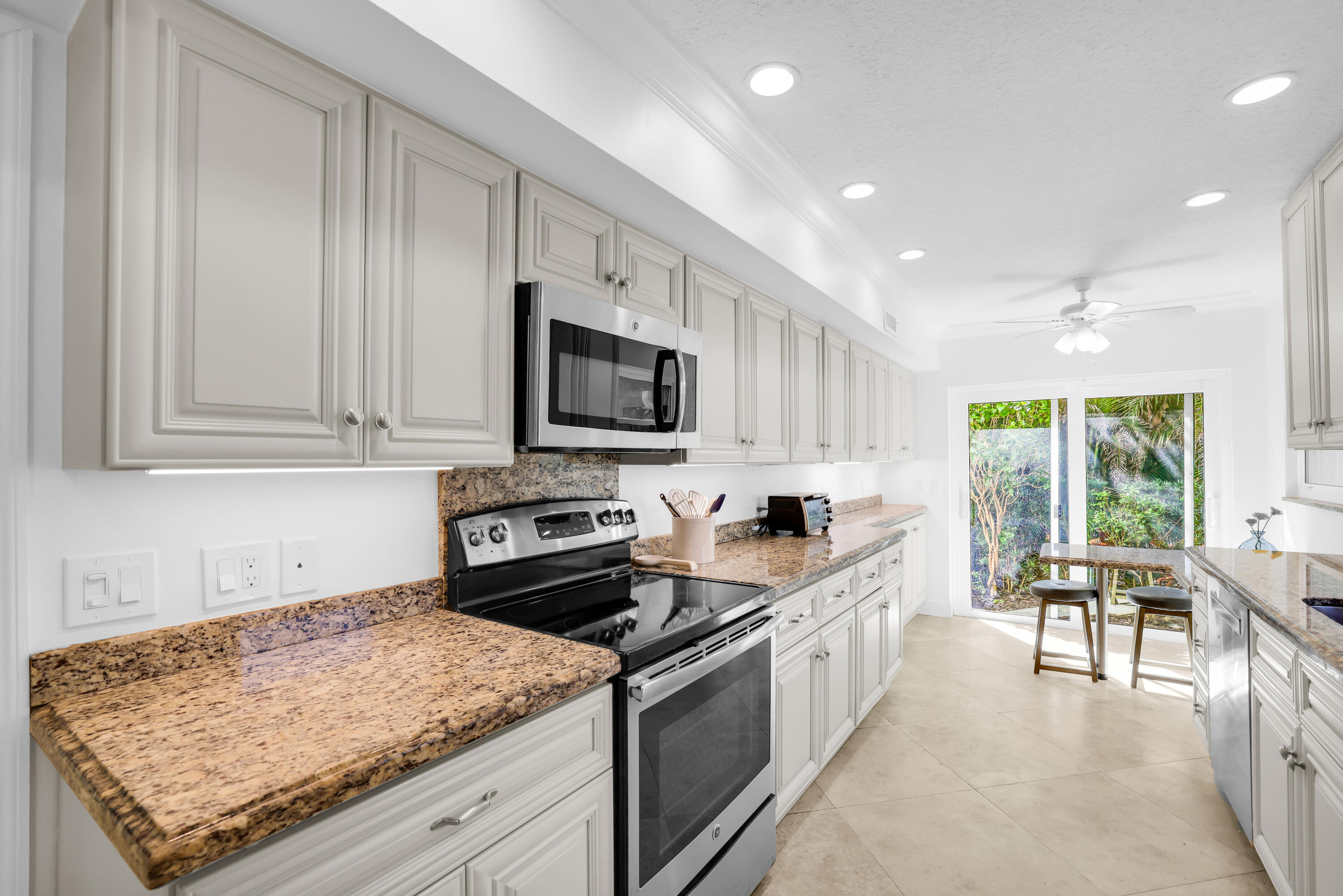4161 U.S. Highway 1, Unit I2 Jupiter, FL 33477 - Photo 13 of 64 a kitchen with a sink stove and microwave