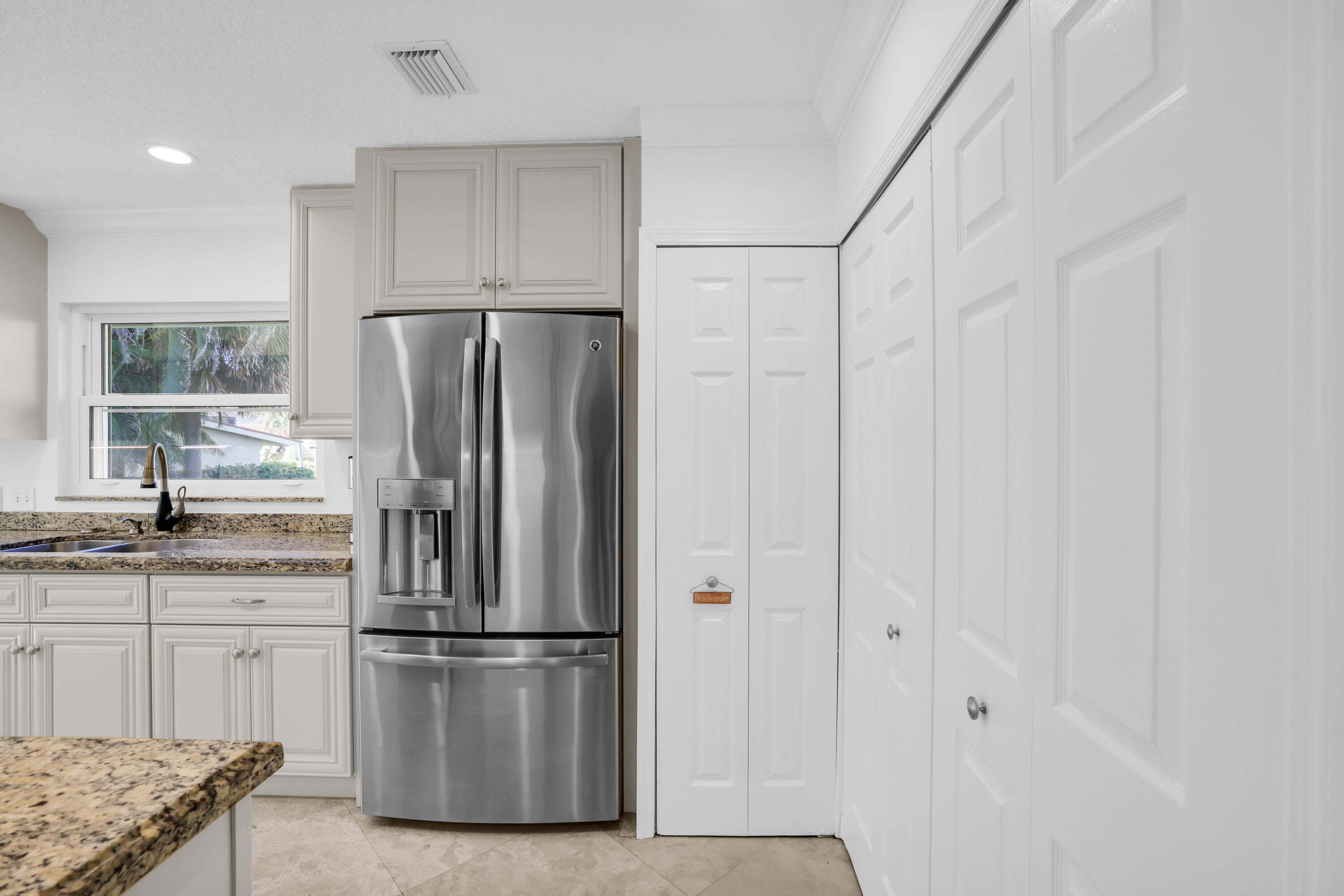 4161 U.S. Highway 1, Unit I2 Jupiter, FL 33477 - Photo 14 of 64 a kitchen with stainless steel appliances a refrigerator and a sink