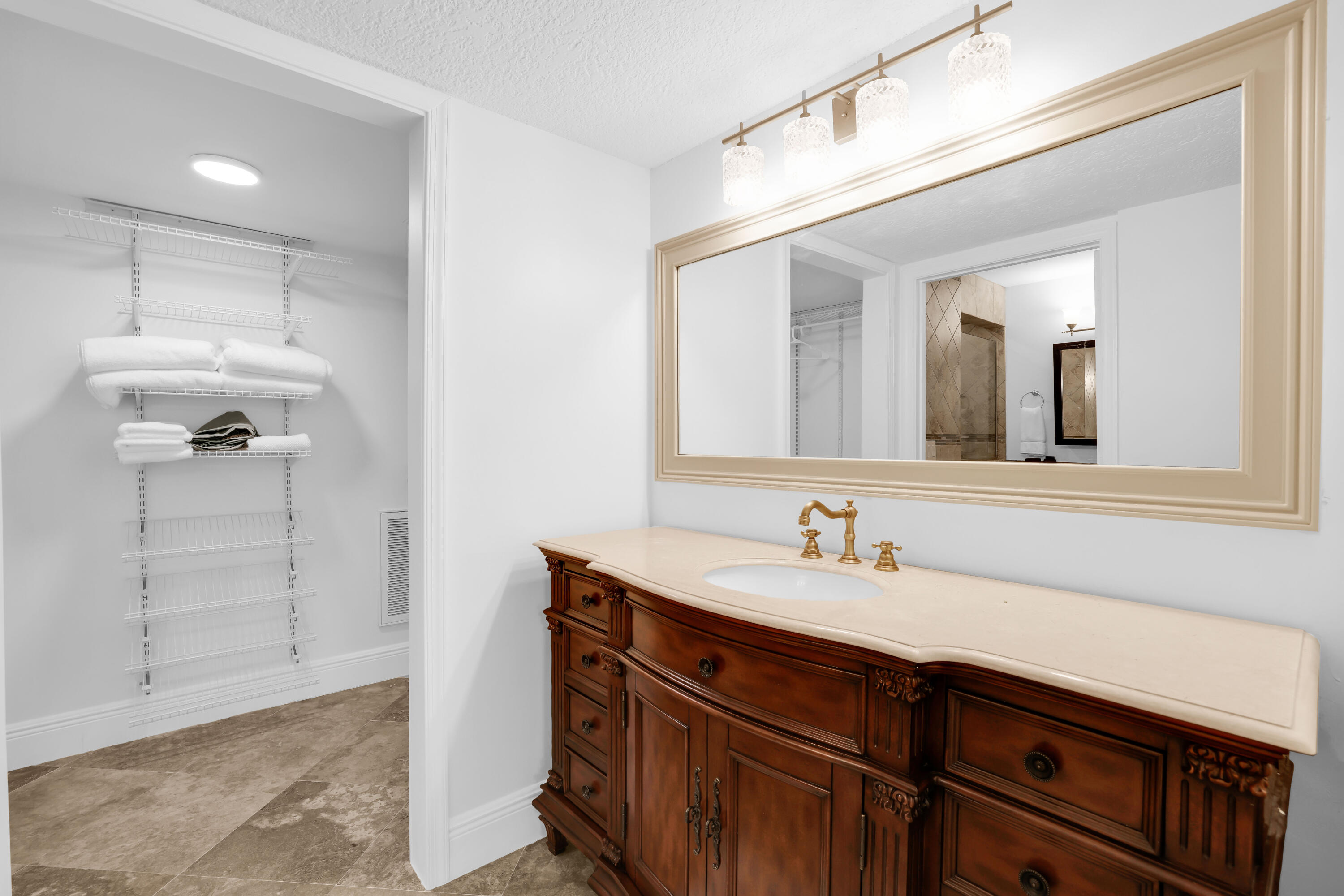 4161 U.S. Highway 1, Unit I2 Jupiter, FL 33477 - Photo 17 of 64 a bathroom with a sink and a mirror