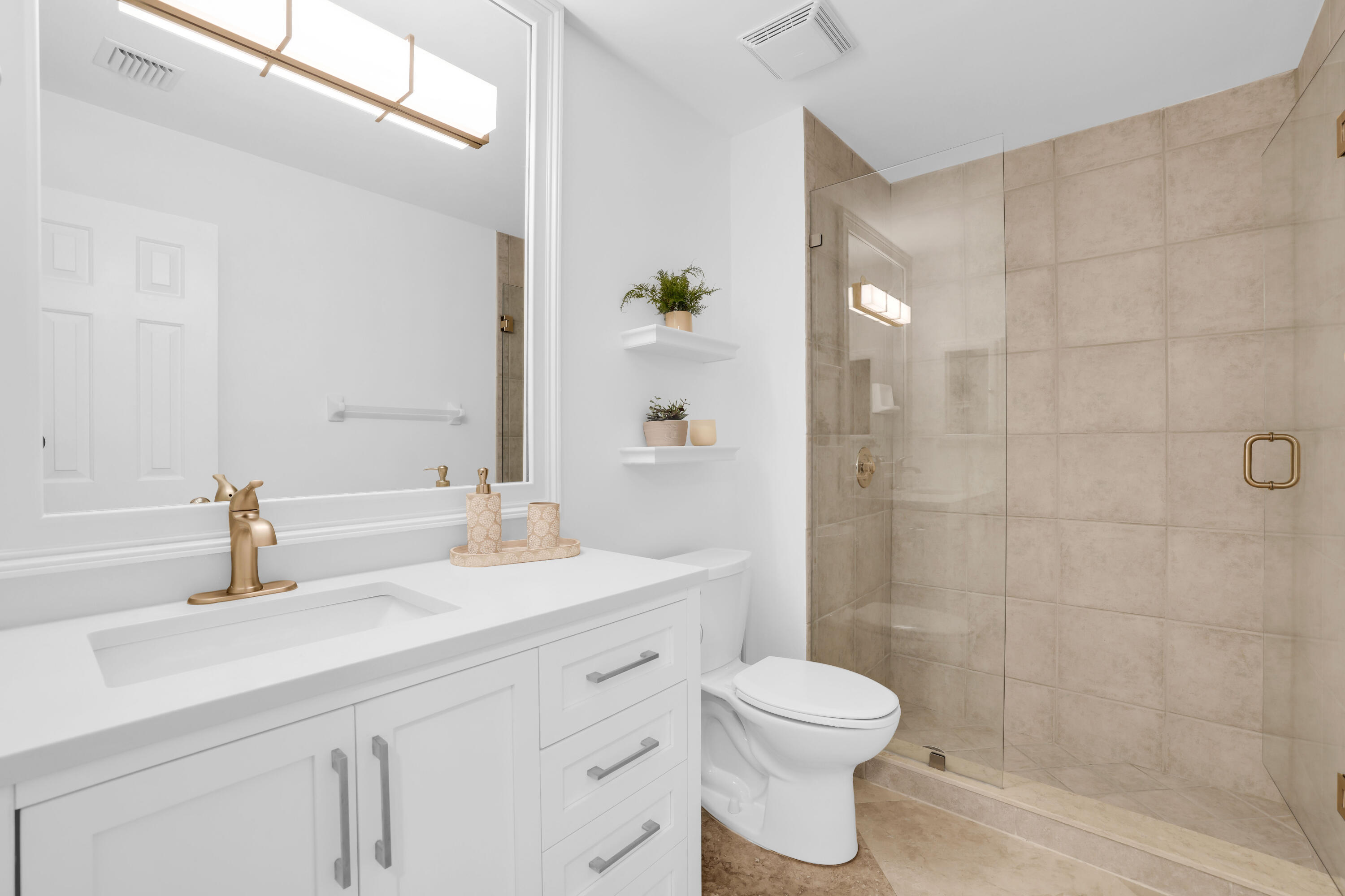 4161 U.S. Highway 1, Unit I2 Jupiter, FL 33477 - Photo 18 of 64 a bathroom with a sink a toilet and shower