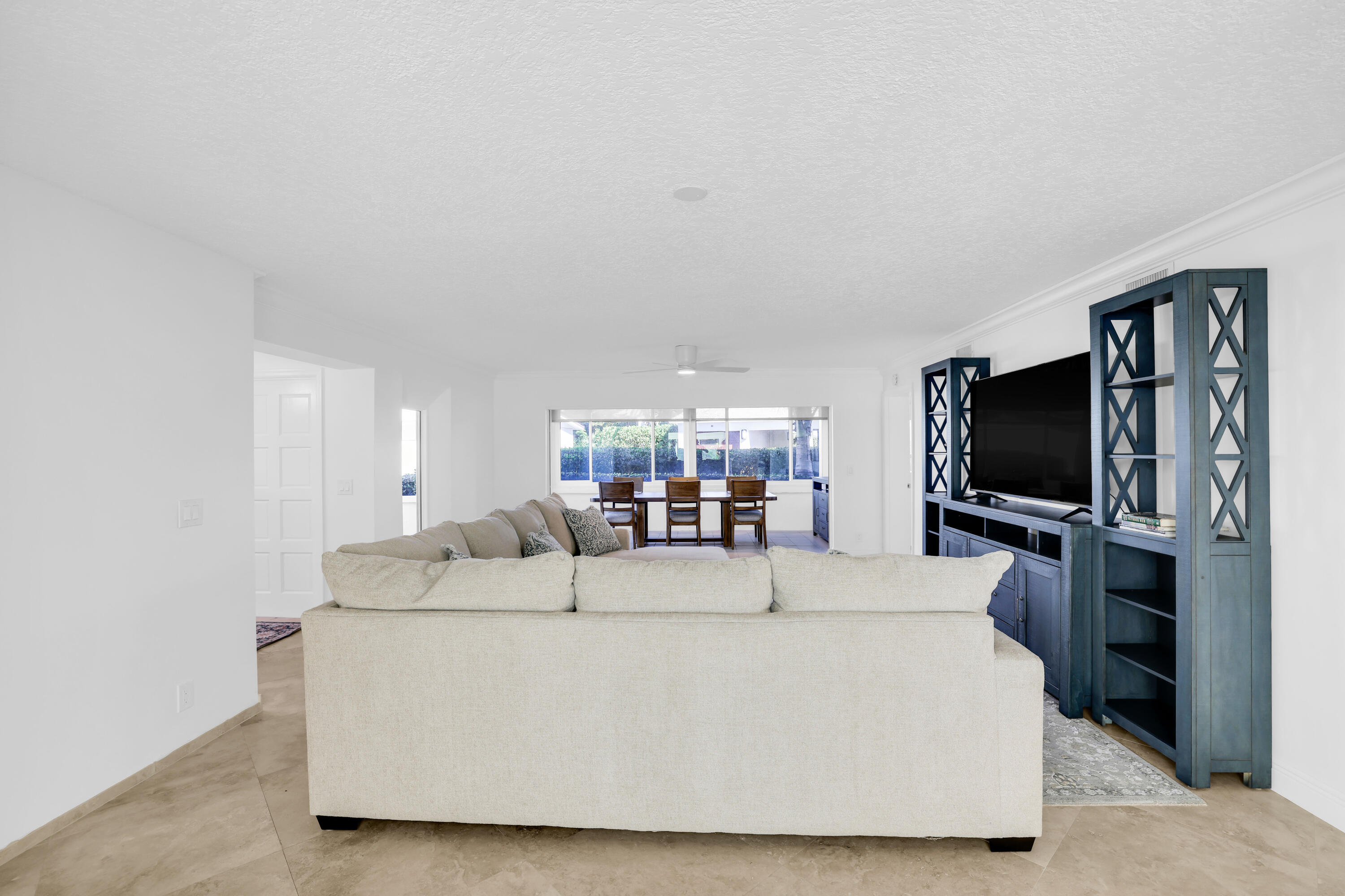 4161 U.S. Highway 1, Unit I2 Jupiter, FL 33477 - Photo 22 of 64 a living room with furniture and a flat screen tv