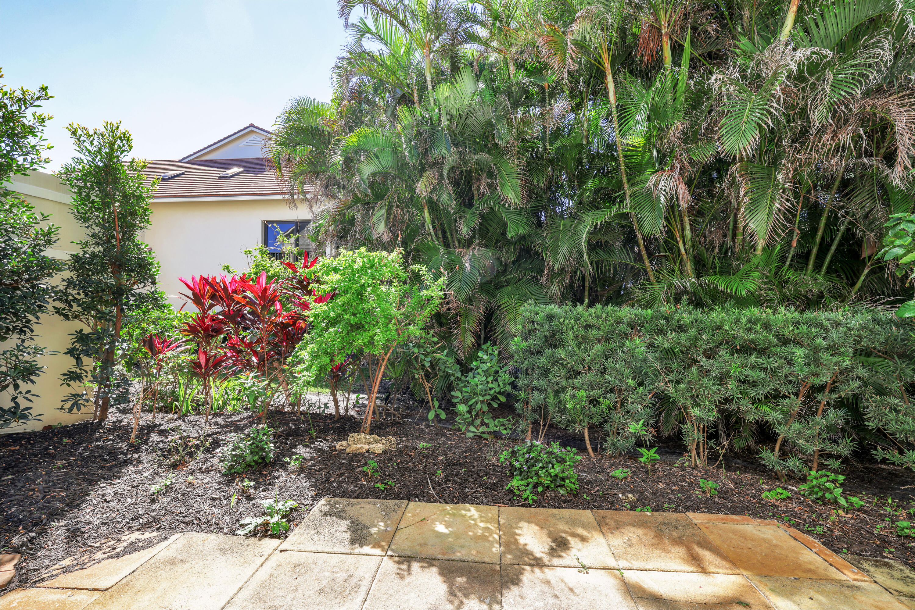 4161 U.S. Highway 1, Unit I2 Jupiter, FL 33477 - Photo 24 of 64 a view of a house with a yard and garden