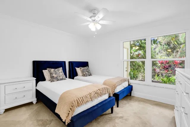 a view of a house with a big yard and large trees