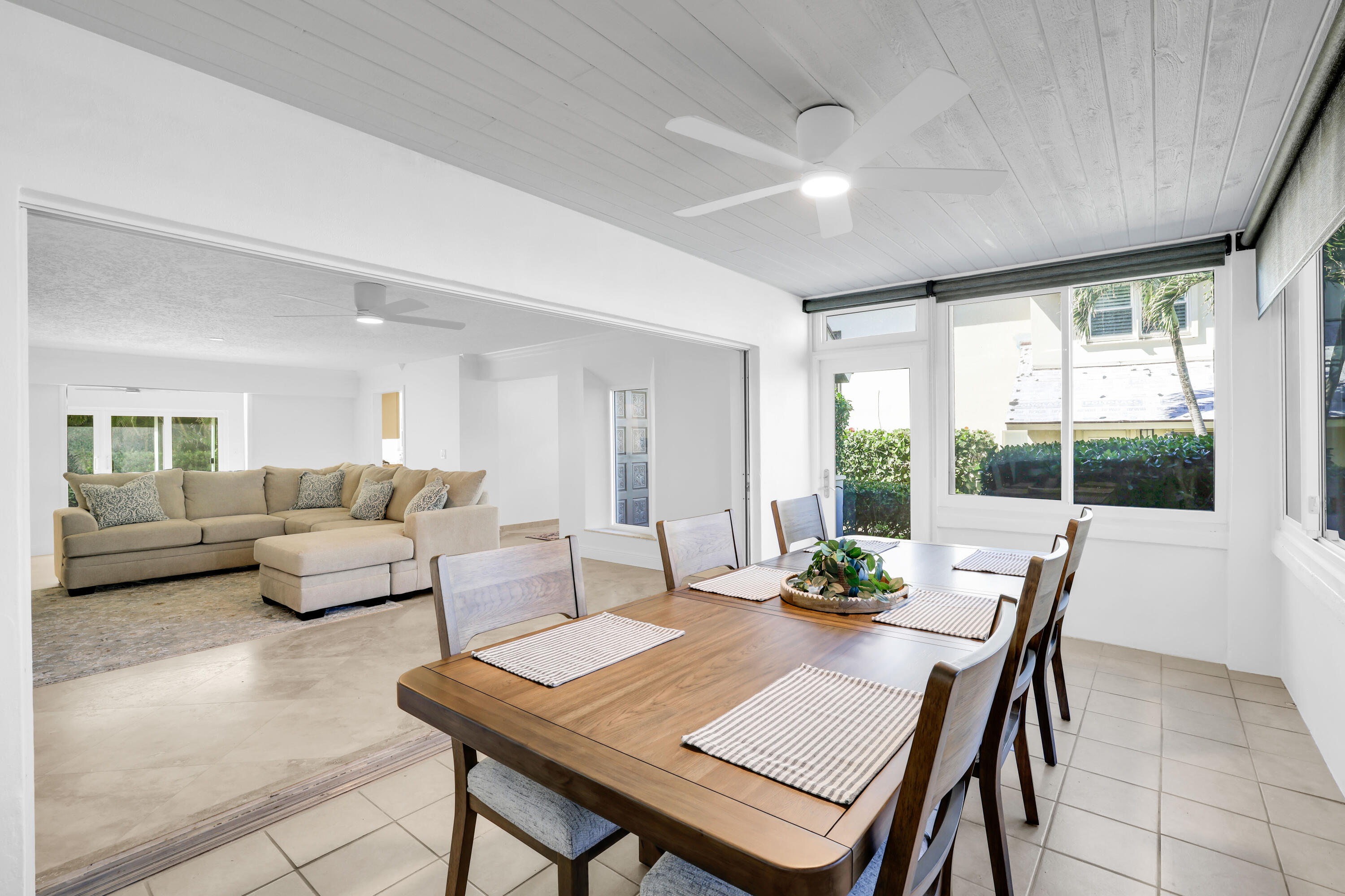 4161 U.S. Highway 1, Unit I2 Jupiter, FL 33477 - Photo 29 of 64 a living room with furniture a table and a large window