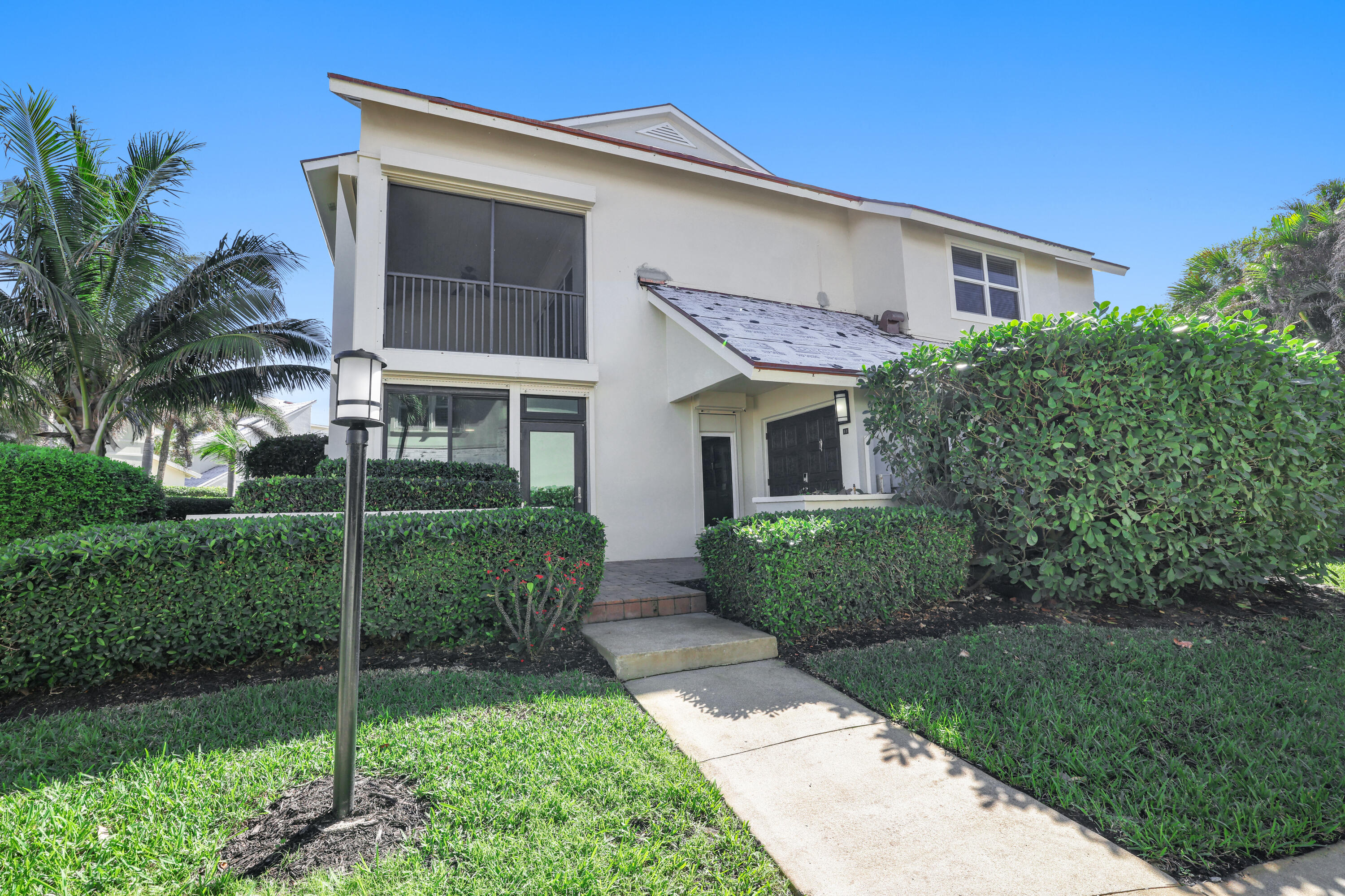 4161 U.S. Highway 1, Unit I2 Jupiter, FL 33477 - Photo 31 of 64 a front view of a house with a garden