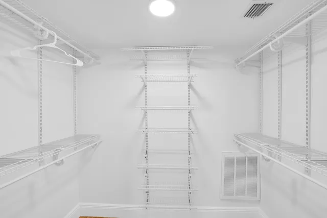 a view of hallway with a window and a rug