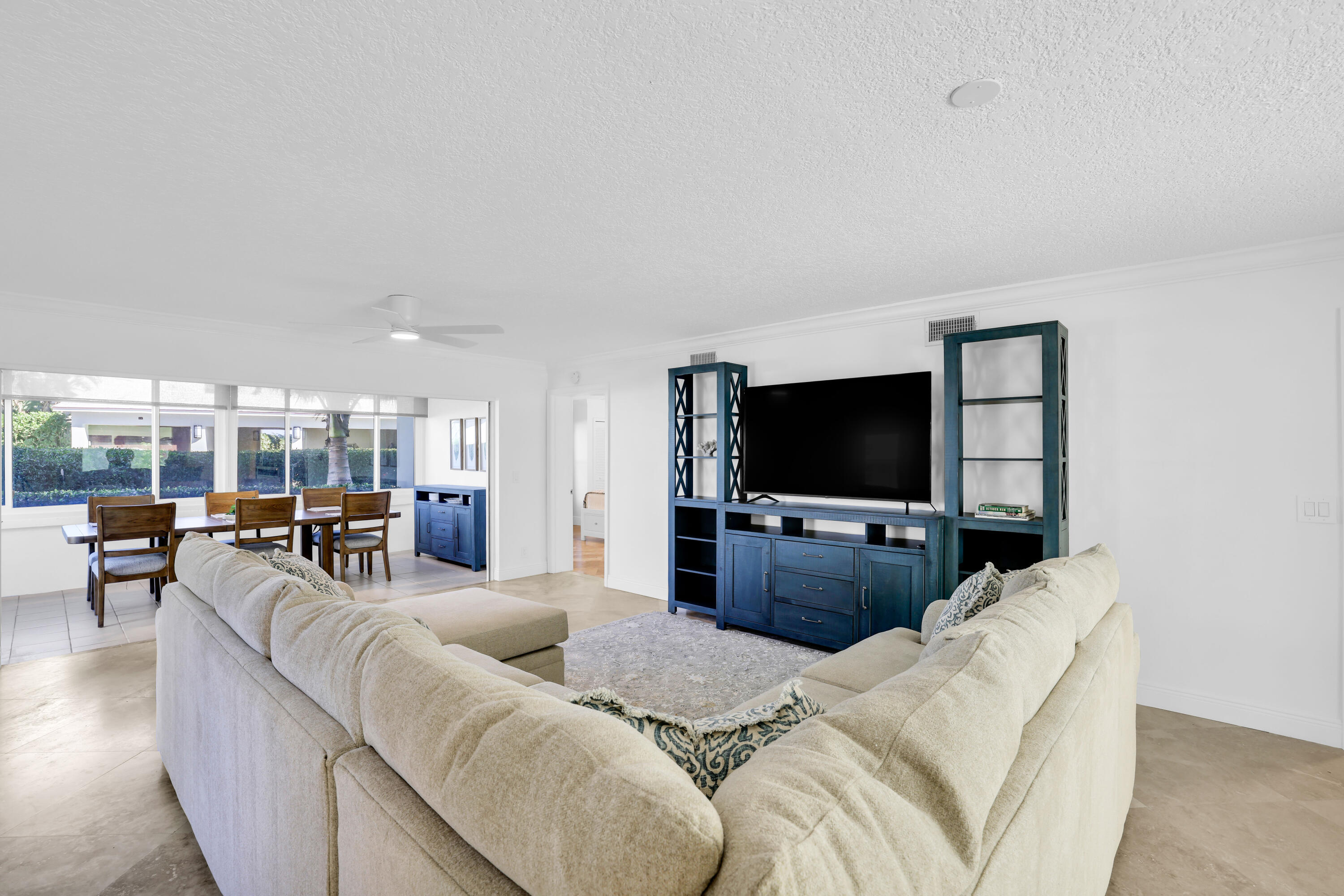 4161 U.S. Highway 1, Unit I2 Jupiter, FL 33477 - Photo 4 of 64 a living room with furniture and a flat screen tv