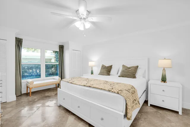 a spacious bedroom with a bed and a large window