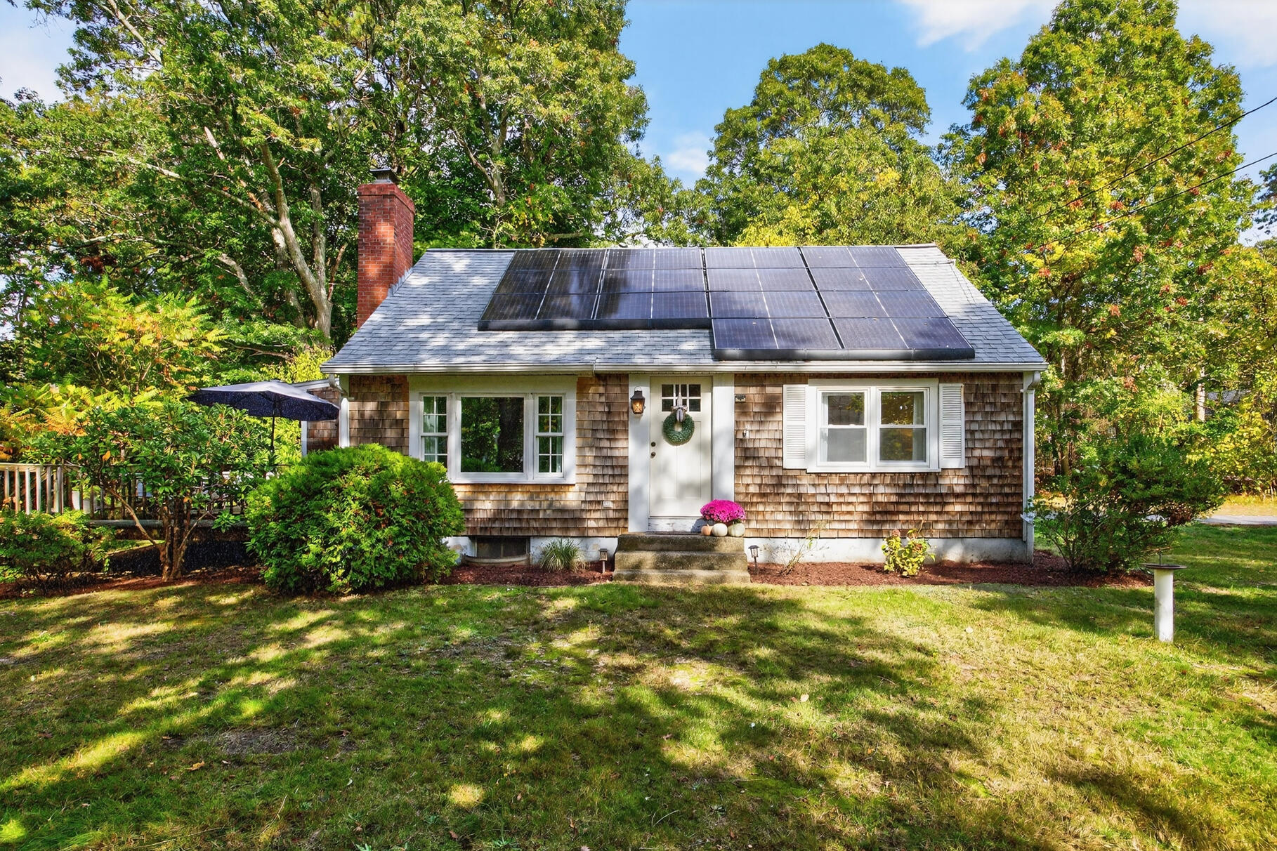 a front view of house with yard and outdoor seating