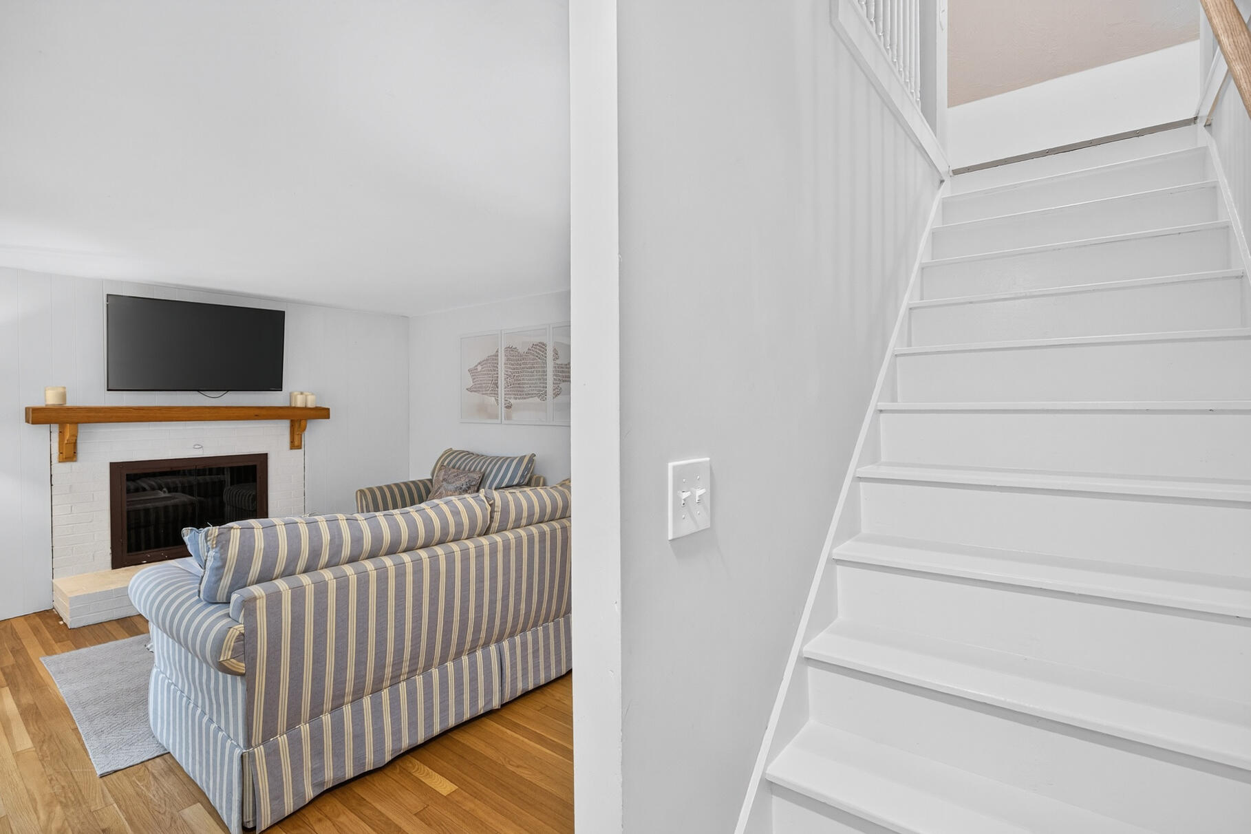 53 Main Street Sandwich, MA 02563 - Photo 15 of 33 a living room with furniture and a fireplace