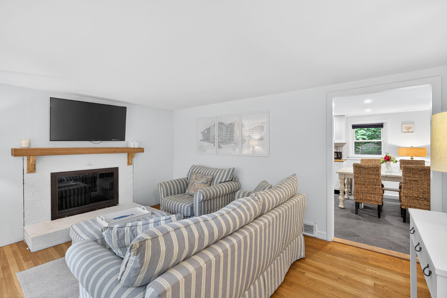 53 Main Street Sandwich, MA 02563 - Photo 4 of 33 a living room with furniture a fireplace and a flat screen tv