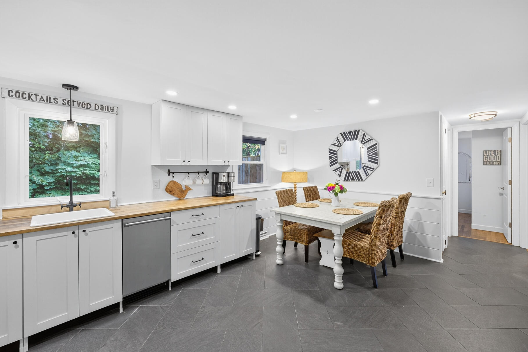 53 Main Street Sandwich, MA 02563 - Photo 5 of 33 a white kitchen with a sink dining table and chairs
