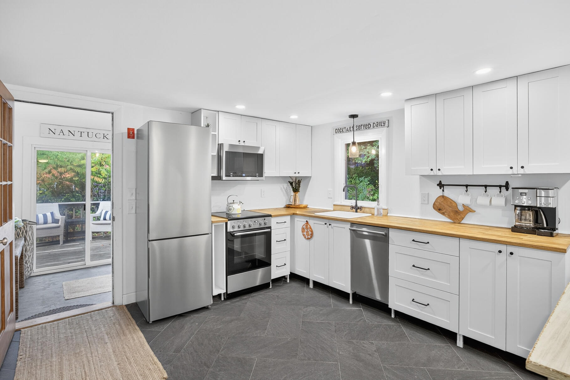 53 Main Street Sandwich, MA 02563 - Photo 7 of 33 a kitchen with granite countertop cabinets and stainless steel appliances