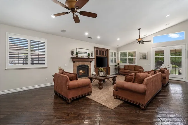 a living room with furniture a fireplace and a window