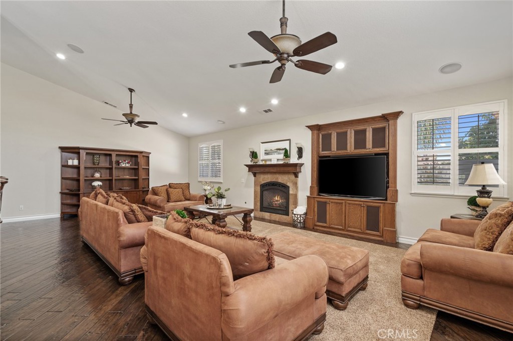 2885 Citrocado Ranch Street Corona, CA 92881 - Photo 12 of 51 a living room with furniture a flat screen tv and a fireplace