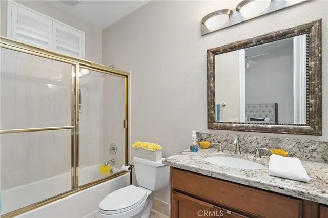 a bathroom with a toilet a sink and a mirror