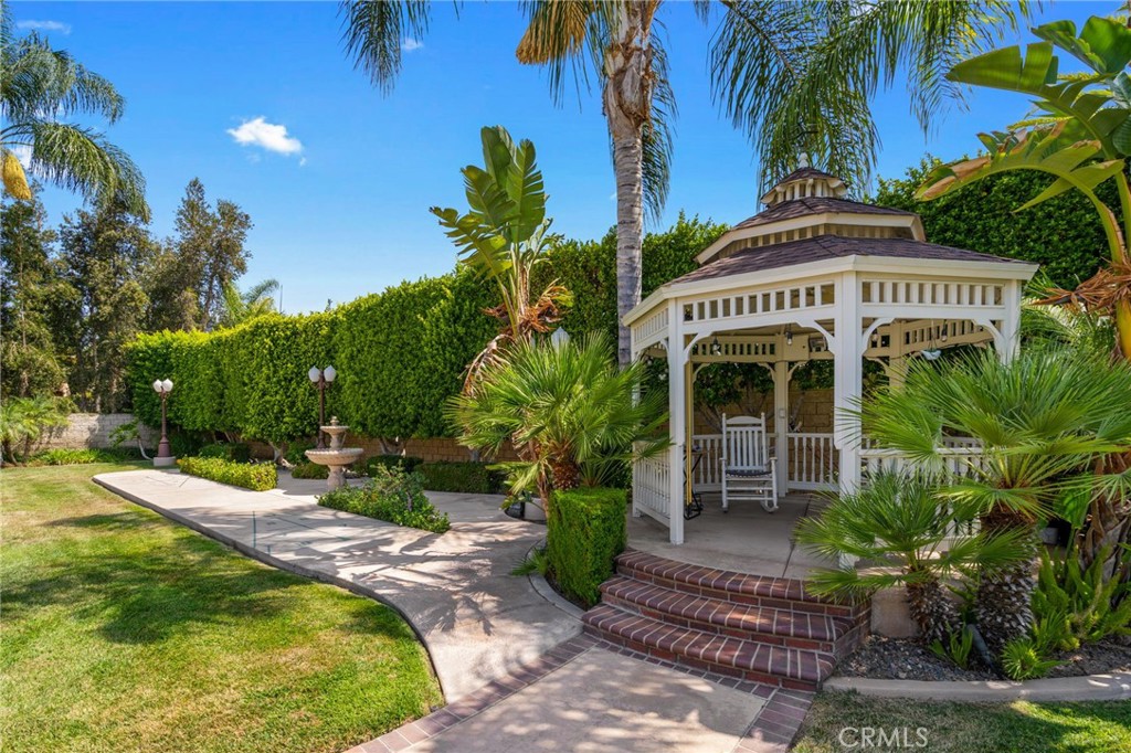 2885 Citrocado Ranch Street Corona, CA 92881 - Photo 36 of 51 a view of a house with a yard and potted plants