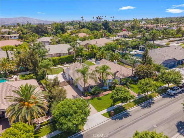 an aerial view of residential houses with outdoor space and street view