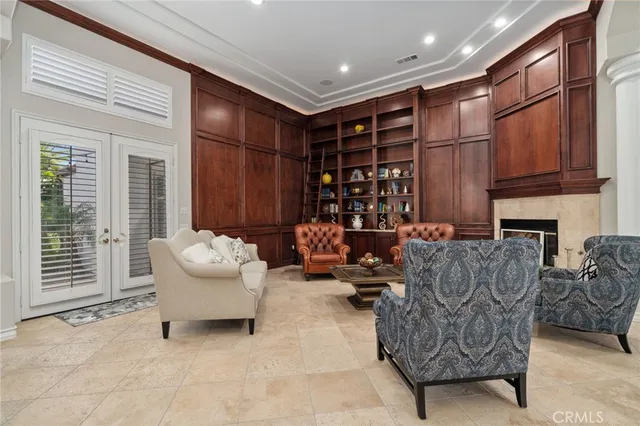 a living room with furniture a fireplace and a large window