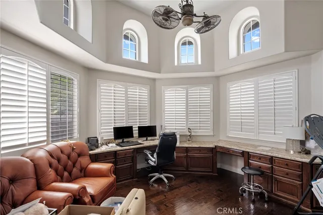 a livingroom with workspace and a window