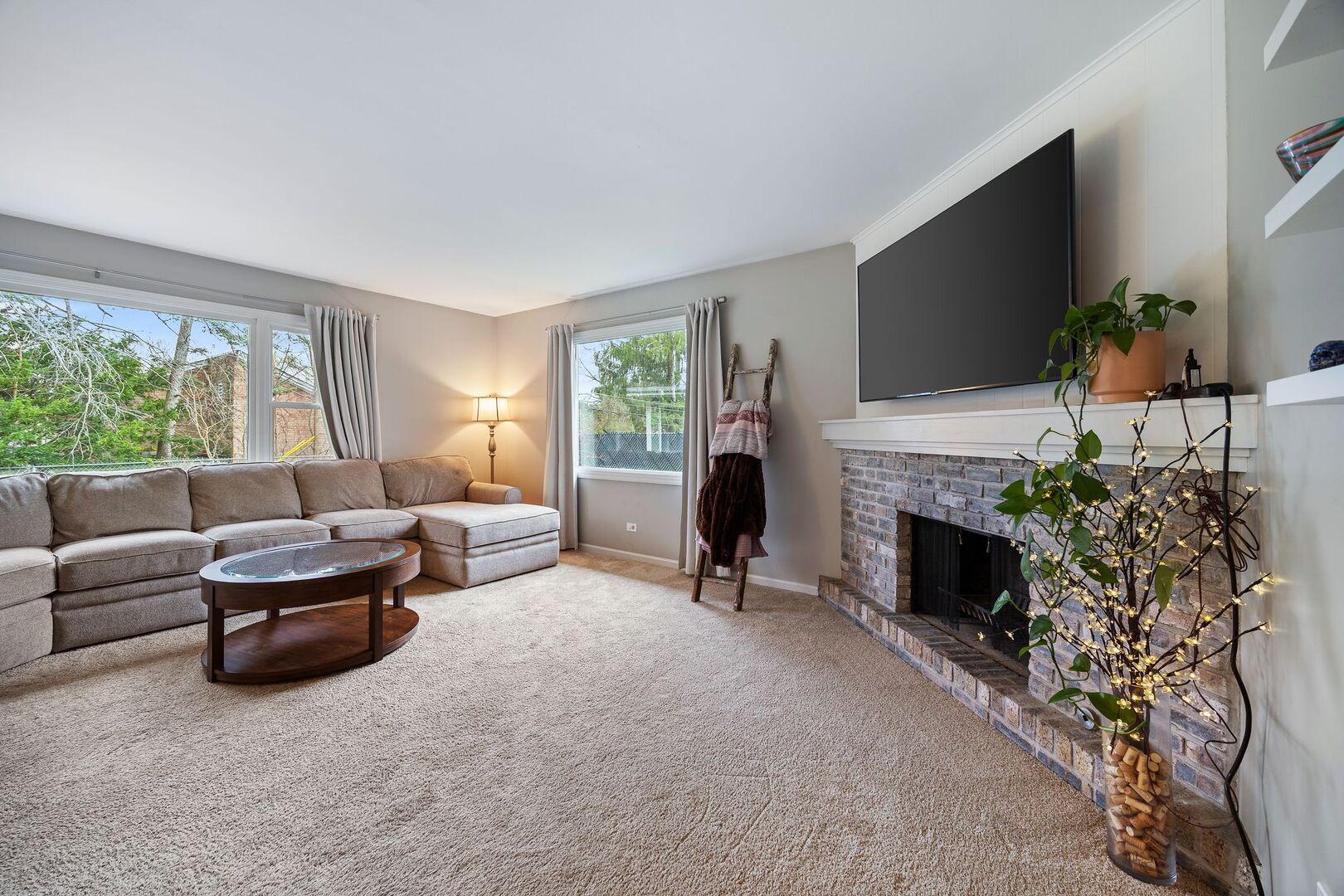 425 North Alfred Avenue Elgin, IL 60123 - Photo 4 of 33 a living room with furniture a fireplace and a flat screen tv
