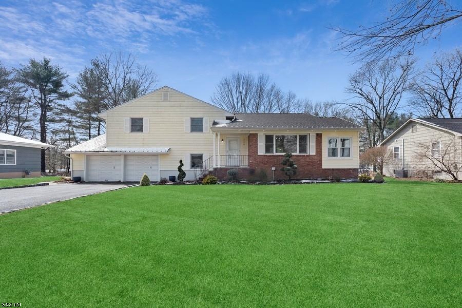 a view of a house with a yard and sitting area