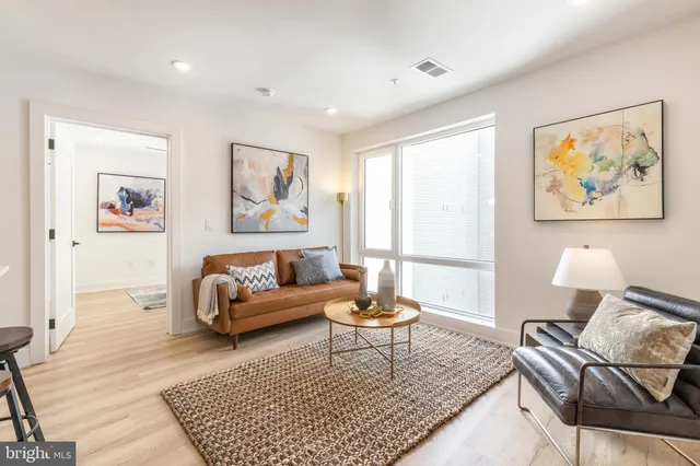 a living room with furniture and a rug