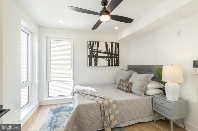 a view of a hallway with wooden floor and entryway