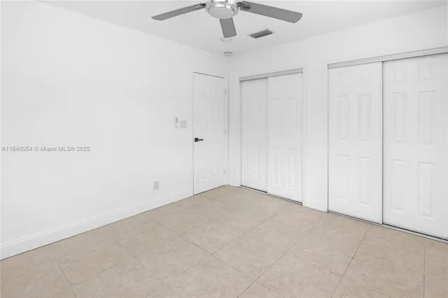 an empty room with a fan